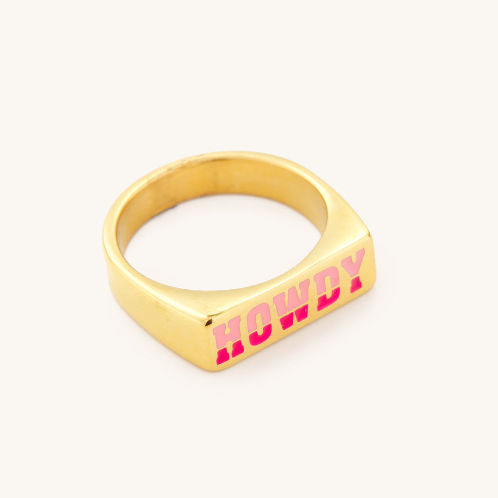 gold ring with pink writing that says howdy. Fashion jewelry
