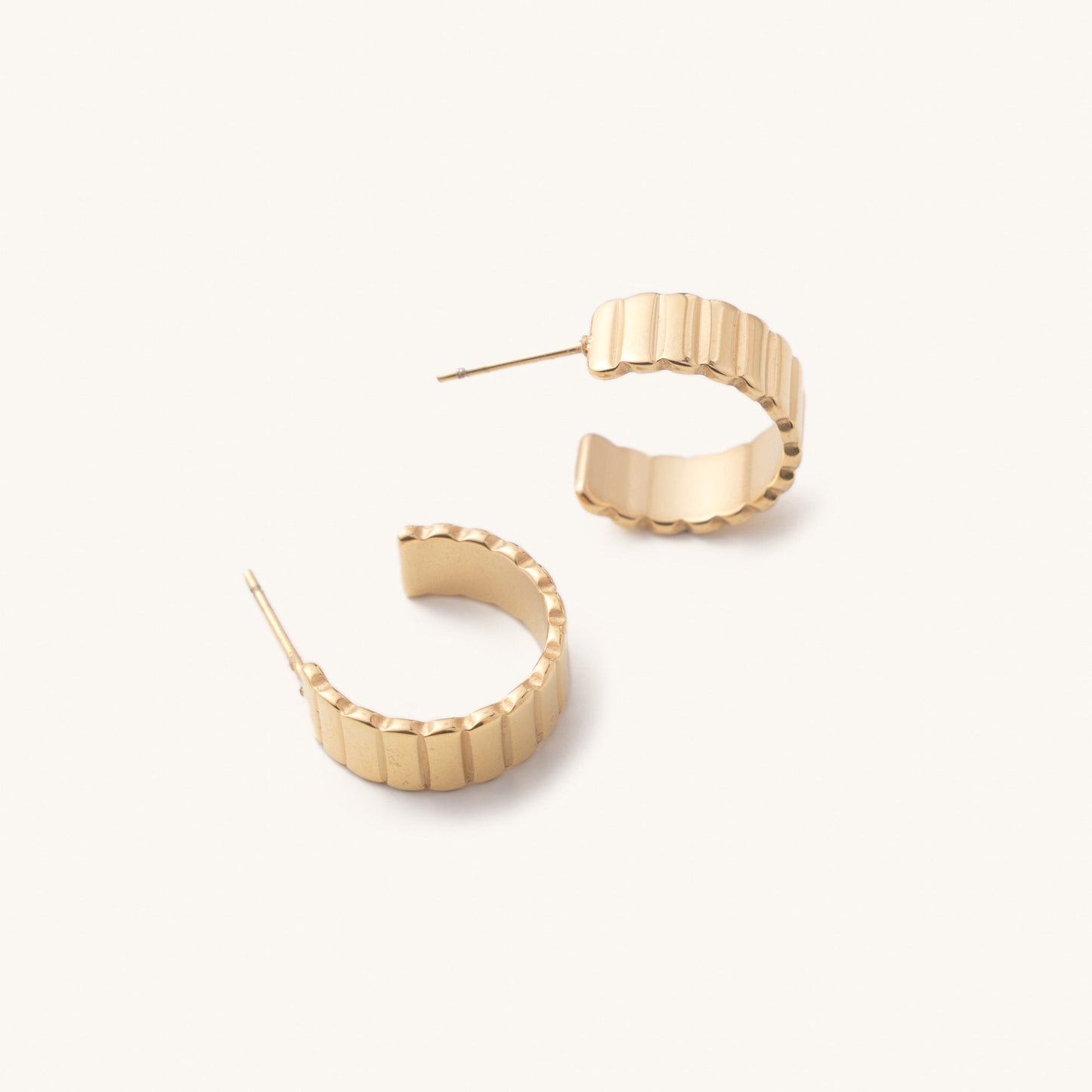 Golden cuffed hoop earring with a ridge