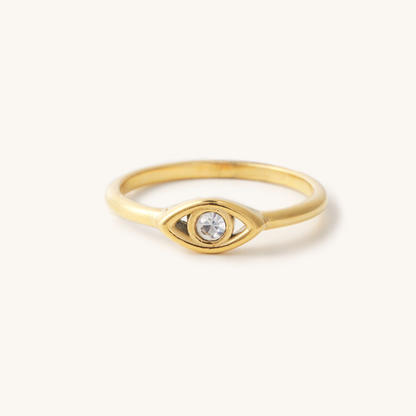 Gold ring with a gem stone evil eve in the center